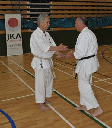 Sensei Tanaka 8th Dan Vice Chief Instructor of the JKA presenting Sensei Morgan with the certificate